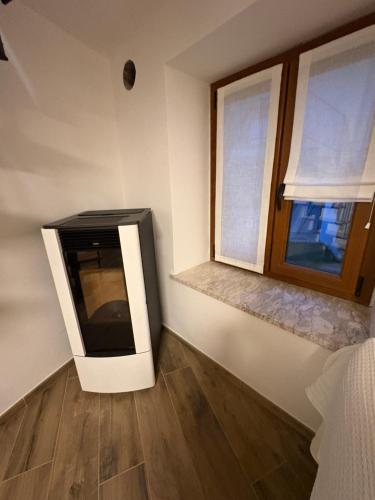 TV en una habitación con ventana en Greenspit House, en Locana