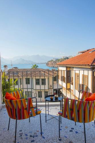 a patio with two chairs and a table and a building at Oldies Hotel in Antalya