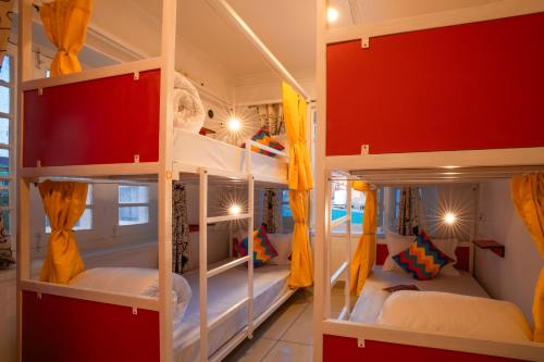 two bunk beds in a room with red walls at goSTOPS Srinagar in Srinagar
