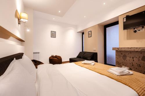 a hotel room with a bed and a fireplace at Apart Meidani - Stylish Old Town Apartment with Balcony & Synagogue View in Tbilisi City