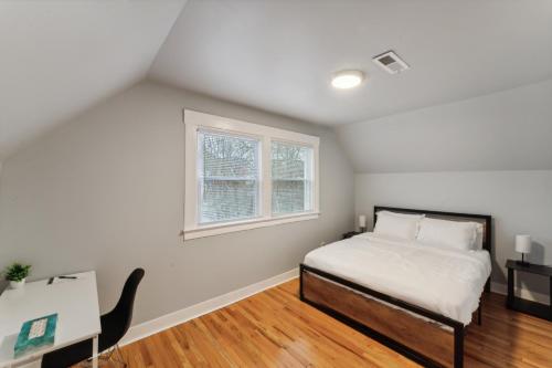 a bedroom with a bed and a desk and a window at The Prospect Hill Suite - Near Yale in New Haven