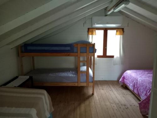 a room with two bunk beds in a attic at Cabaña SOPHIA in Tigre