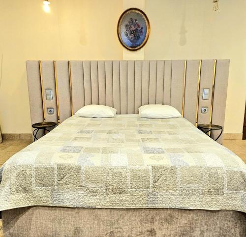 a bedroom with a large bed with a large headboard at Equinaturi in Santo Tirso