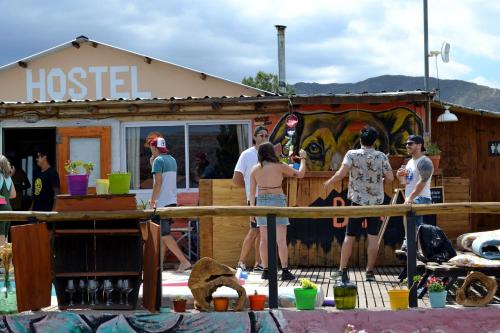 a group of people standing in front of a hostel at Hostel Bar Valle de Potrerillos in Potrerillos