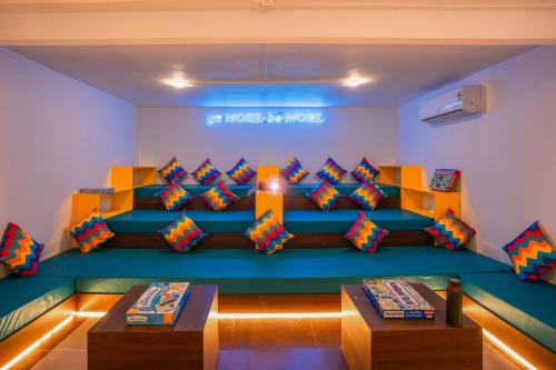 a room with a couch with colorful pillows at goSTOPS Srinagar in Srinagar