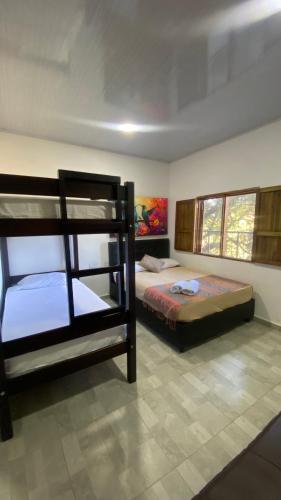 a bedroom with two bunk beds in it at Coffee House Minca in Minca