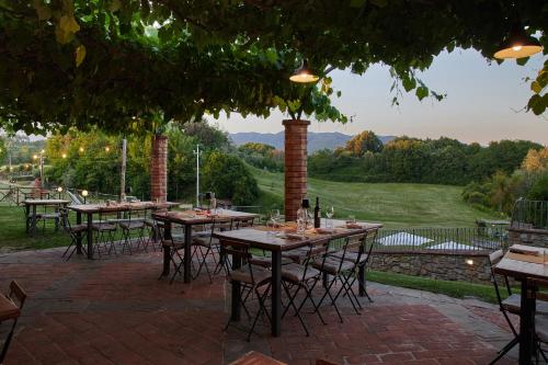 a patio with tables and chairs with a view at Casa Vacanze Le Fornaci in Laterina
