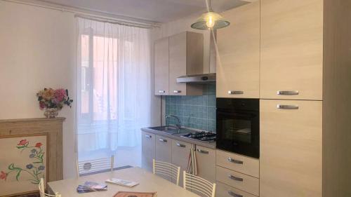 a kitchen with a table and a sink and a stove at la casa della Poetessa in Orte
