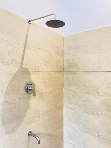 a shower with a shower head in a bathroom at Villa Minos in Hikkaduwa