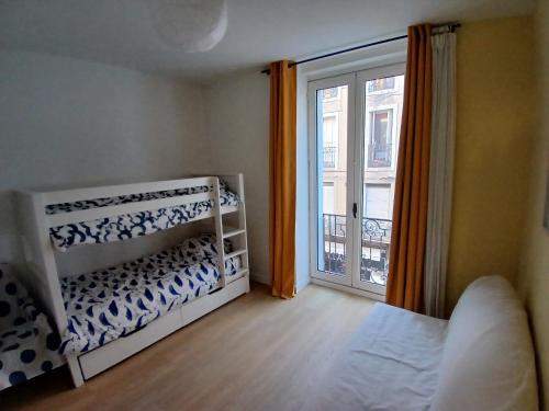 une chambre avec un lit et une grande fenêtre dans l'établissement Beau 3 pièces climatisé vue Canal idéalement situé Centre Ville, à Sète