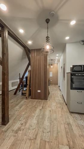 an empty room with a kitchen and a hallway at Forest Loft Apart in Alfeld