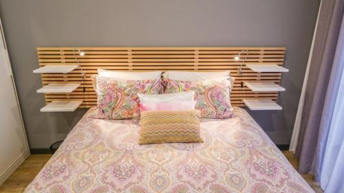 a bedroom with a bed with pillows on it at Cilio House in Ponta Delgada