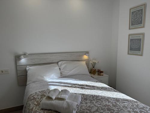 a bedroom with a bed with two towels on it at Cabosun in El Cabo de Gata