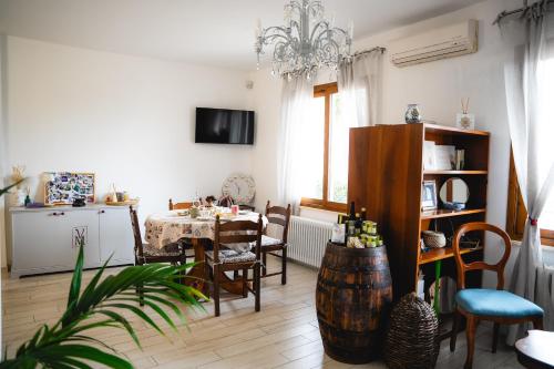 a living room with a table and a dining room at Villa Mafalda in Pietra Ligure