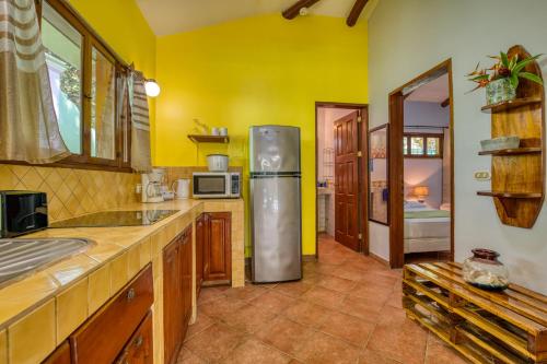 a kitchen with a stainless steel refrigerator in a room at Villas Verdes in Sámara
