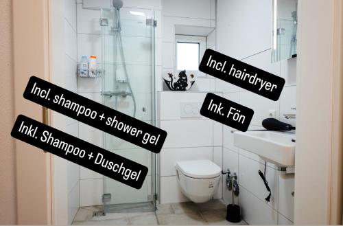 a bathroom with black signs on the wall of a toilet at Sepperls Stubn Apartment - PETS no extra cost - Bad Goisern - 24-hours Self check-in in Bad Goisern