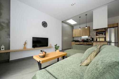 a living room with a couch and a table at Modern Spacious Apartment in Kissamos