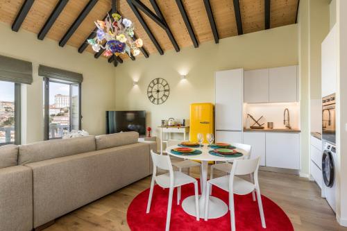 a living room with a couch and a table and chairs at Douro's Balcony View - Swimming pool in Vila Nova de Gaia