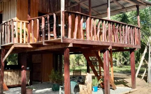 a wooden deck on the side of a house at La Chonta de Corcovado in Puerto Jiménez