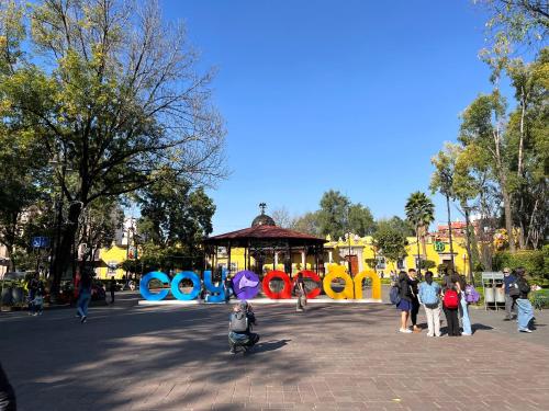a group of people walking around a park at Artisanal Loft Coyoacan in Mexico City