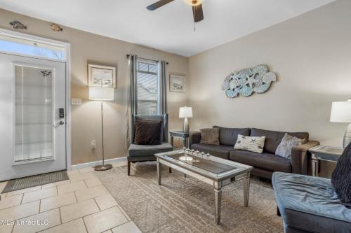 a living room with a couch and a table at Sunset Beach Hideaway in Gulfport