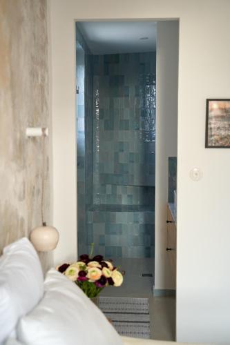 a bathroom with a shower with a vase of flowers at Le Petit Croquant in Marseille