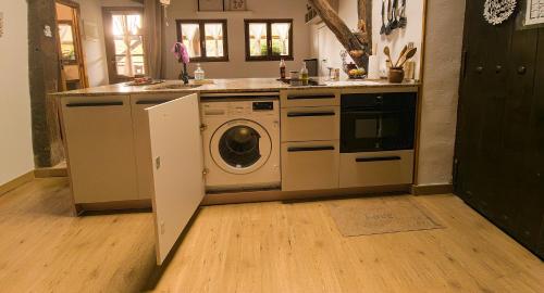 a kitchen with a sink and a washing machine at BIDEARTEAN, Caserío vasco, Recién reformado in Záitegui