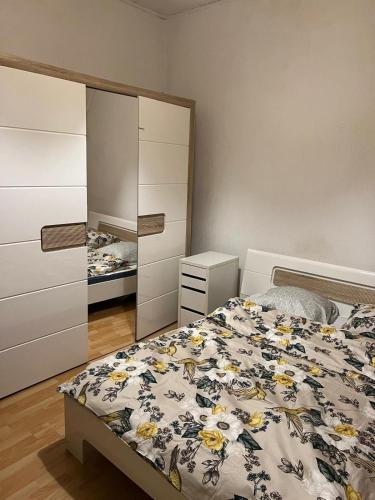 a bedroom with a bed and a dresser and a mirror at Motel Schwanen in Schlattingen