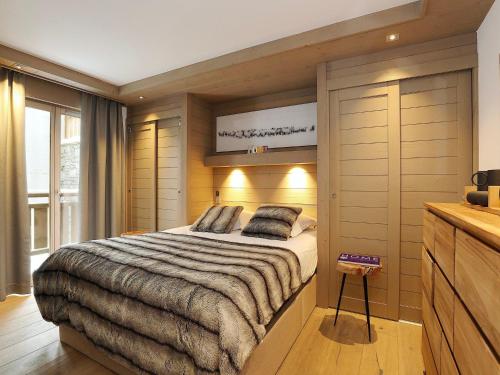 a bedroom with a large bed and a television at Appartement familial 3 chambres à Courchevel, parking et proche des pistes - FR-1-575-130 in Courchevel
