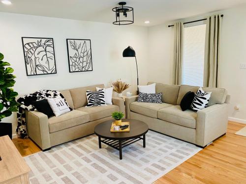 a living room with a couch and a table at Family Favorite Heart of The Hill in Saint Louis