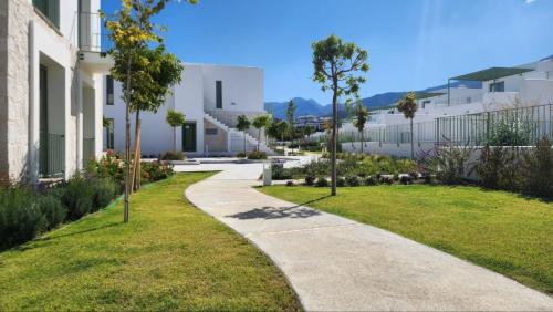 a walkway in a yard next to a building at Lapta Residential Complex IRINA in Lapithos