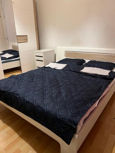 a bedroom with a bed with a black comforter at Motel Schwanen in Schlattingen