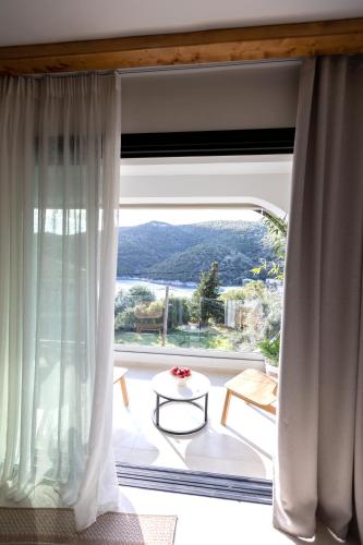 a room with a large window with a view at Aella Exclusive Residences Lefkada in Mikros Gialos