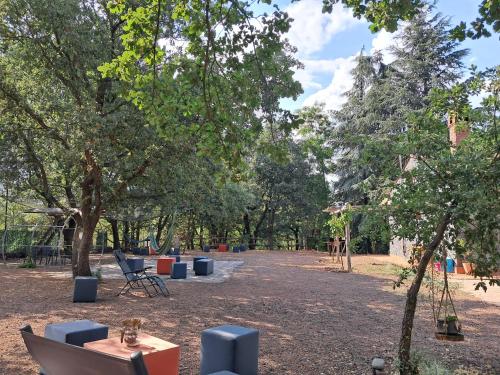 a picnic area in a park with chairs and trees at Casa etna in Bronte