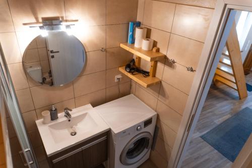 a bathroom with a washing machine and a sink at Alina's House in Arachova