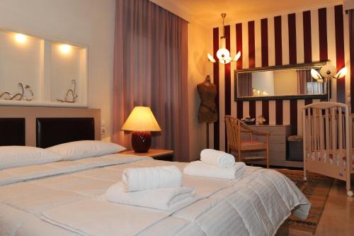 a bedroom with two beds and a crib in it at Stergios Garden House in Kalabaka