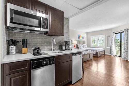 a kitchen with a sink and a microwave at 14-Near Universal Studios Amazing View in Orlando