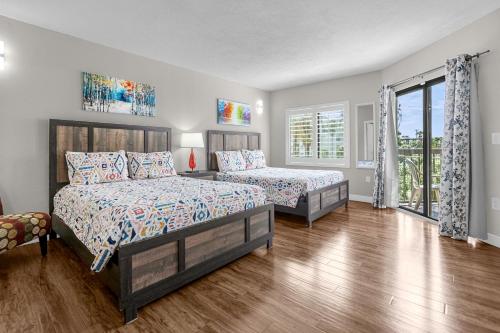 a bedroom with two beds and a large window at 14-Near Universal Studios Amazing View in Orlando