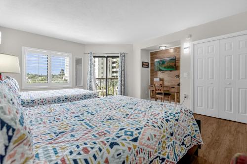 a bedroom with two beds and a desk and a window at 14-Near Universal Studios Amazing View in Orlando