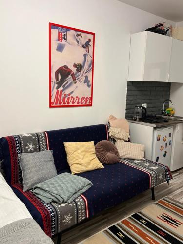 a living room with a couch with pillows on it at Gudauri Loft Apartment 416 in Gudauri
