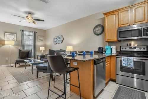 a kitchen and living room with a table and chairs at Sunset Beach Hideaway in Gulfport