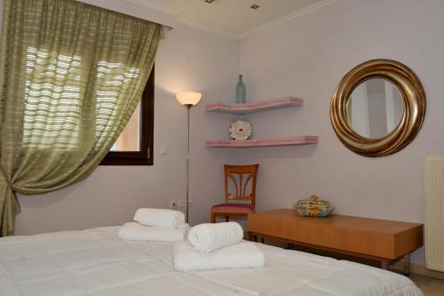 a bedroom with a bed and a table and a mirror at Stergios Garden House in Kalabaka