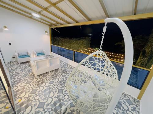a swing on the balcony of a house at Mansion Parque Lleras Poblado Medellin in Medellín