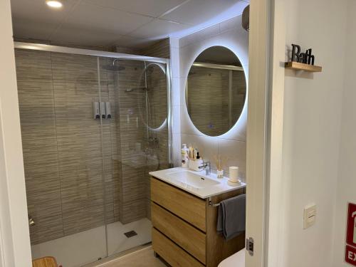 a bathroom with a shower and a sink and a mirror at Cabosun in El Cabo de Gata