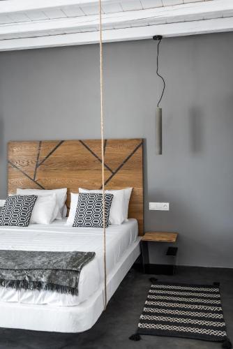 a bedroom with a swing bed in a room at Mykonos Residence Villas & Suites Merchia beach in Merchia Beach