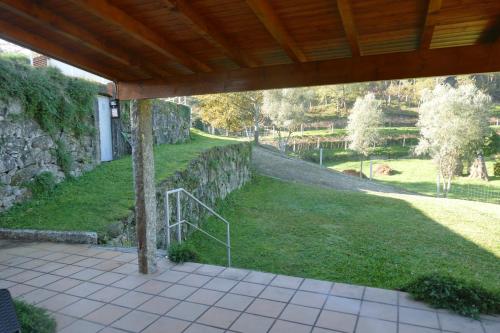 a view of a yard with a stone wall at Casa nos Penedos in Arcos de Valdevez