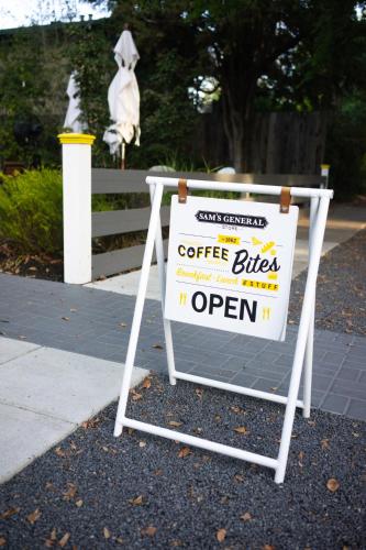 a sign that says coffee filter open on a sidewalk at Brannan Cottage Inn in Calistoga