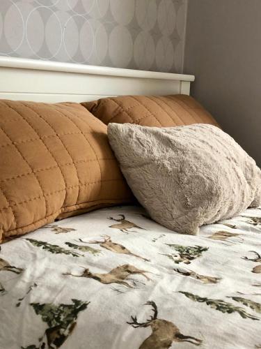 a bed with a blanket and a pillow on it at Cozy room surrounded by nature in Falun