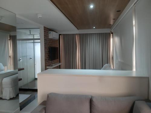 a living room with a couch and a large window at Reserva Madero 201 Vista Mar in Natal