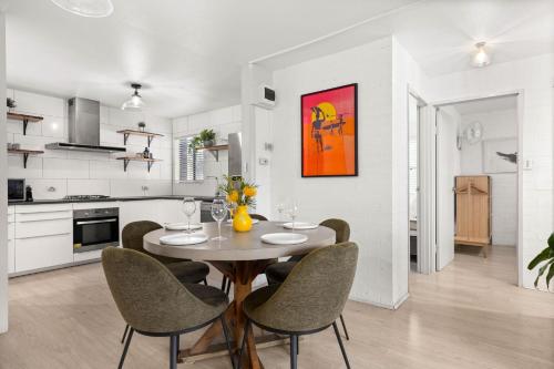 a kitchen and dining room with a table and chairs at Bayswell by Experience Jervis Bay in Huskisson